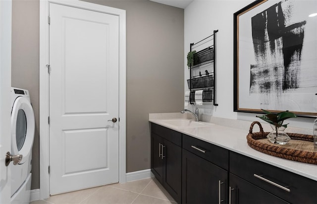 2741 Serenity Meadow Dr, Kissimmee, FL 34744 - bathroom featuring baseboards, tile patterned flooring, vanity, and washer / clothes dryer