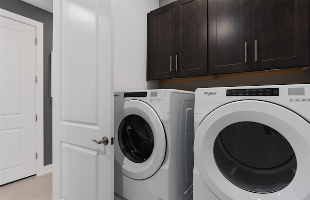 2741 Serenity Meadow Dr, Kissimmee, FL 34744 - laundry room featuring washing machine and dryer, baseboards, light tile patterned floors, and cabinet space