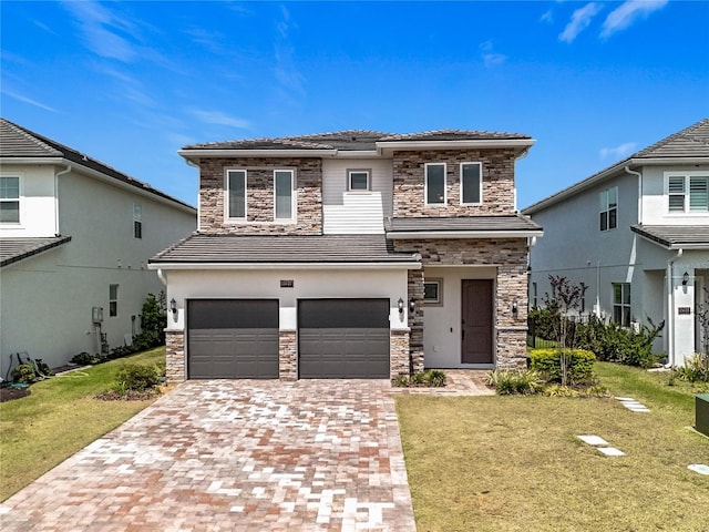 view of front of house featuring decorative driveway, a front lawn, stone siding, and an attached garage