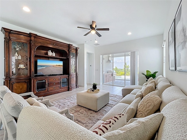 living room with visible vents, recessed lighting, light wood-type flooring, and a ceiling fan