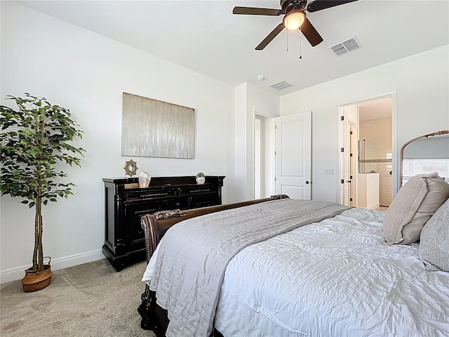 carpeted bedroom with connected bathroom, visible vents, ceiling fan, and baseboards