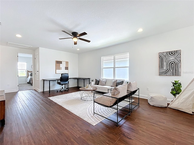 living room with wood finished floors, a ceiling fan, and baseboards