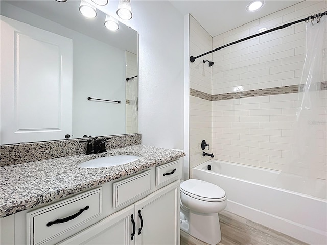 bathroom featuring wood finished floors, shower / tub combo with curtain, toilet, and vanity