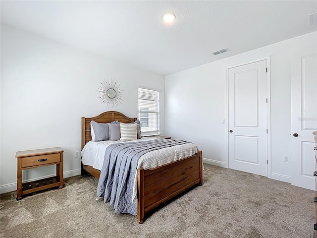 bedroom featuring baseboards, visible vents, and carpet floors