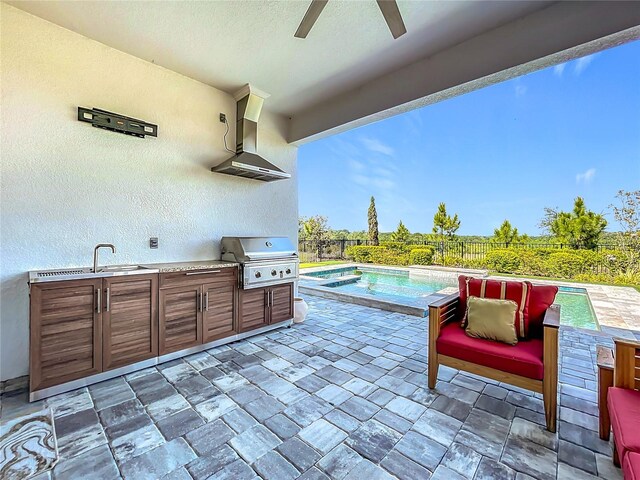 view of patio / terrace with exterior kitchen, area for grilling, a ceiling fan, an outdoor pool, and fence