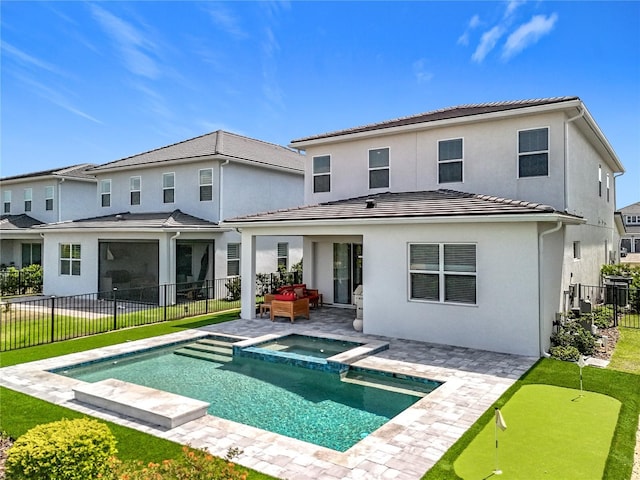 back of house with stucco siding, a tiled roof, fence private yard, a pool with connected hot tub, and a patio area