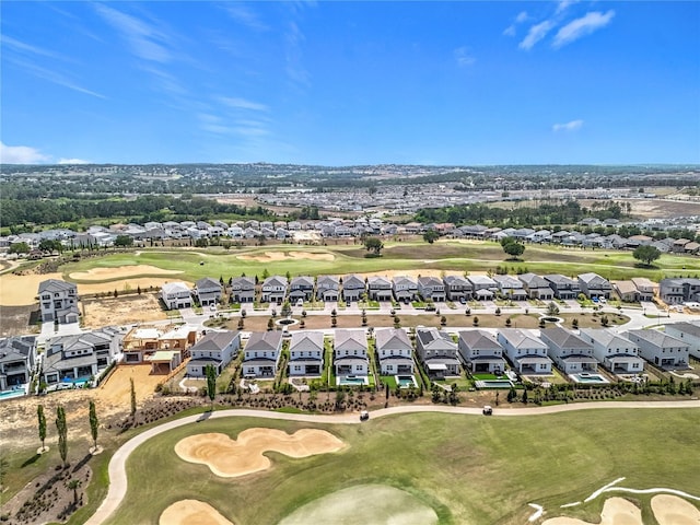 birds eye view of property with golf course view and a residential view
