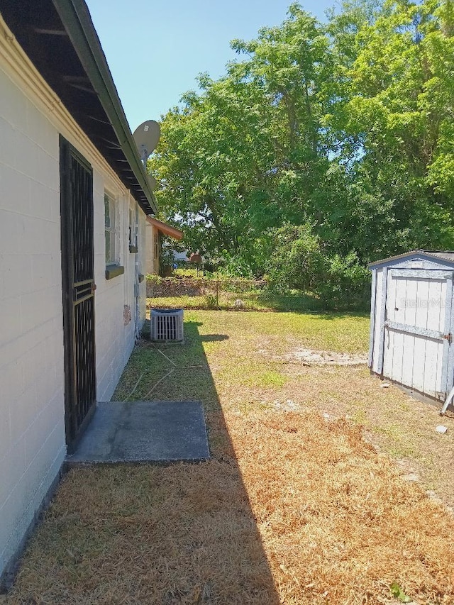 view of yard featuring a storage shed and an outbuilding