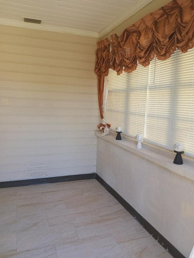 unfurnished room with baseboards and ornamental molding