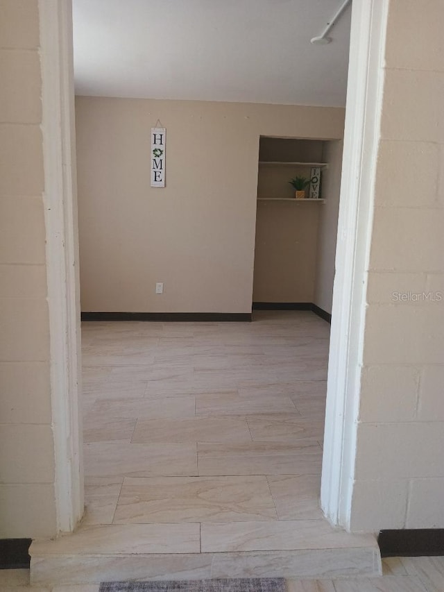 unfurnished room featuring baseboards