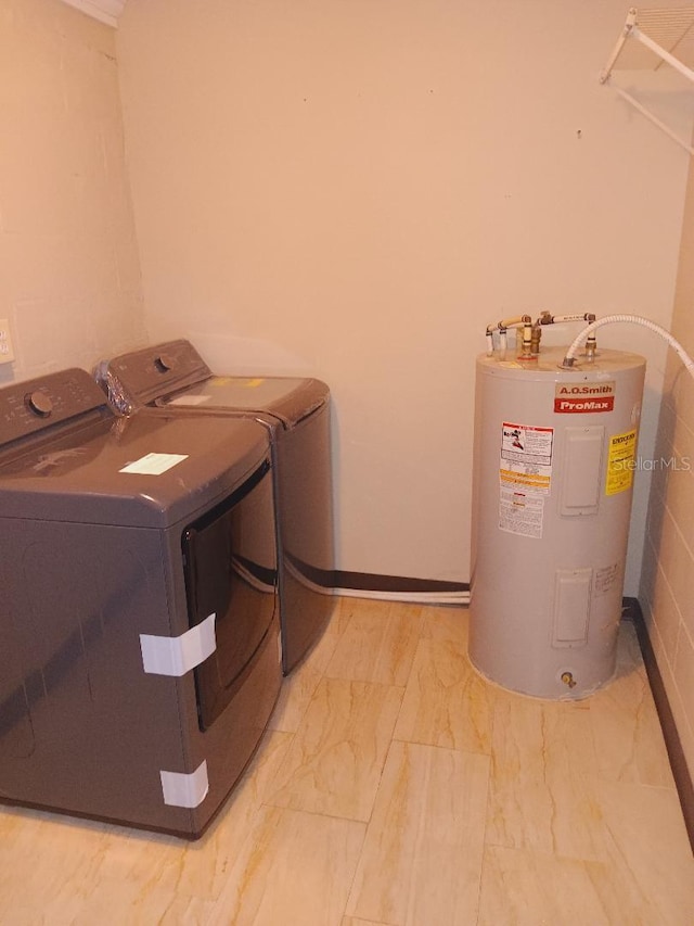 laundry room with separate washer and dryer, electric water heater, marble finish floor, and laundry area
