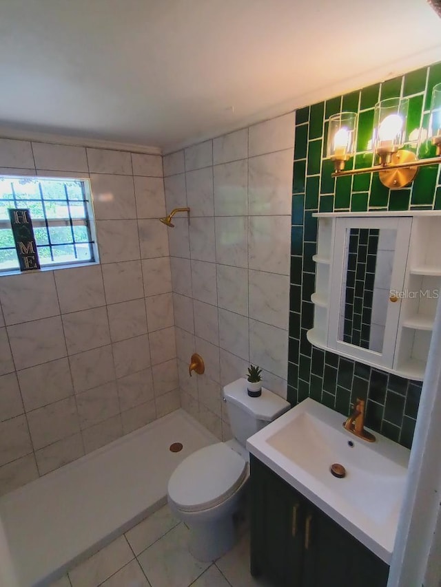 bathroom featuring a tile shower, toilet, tile patterned floors, and tile walls