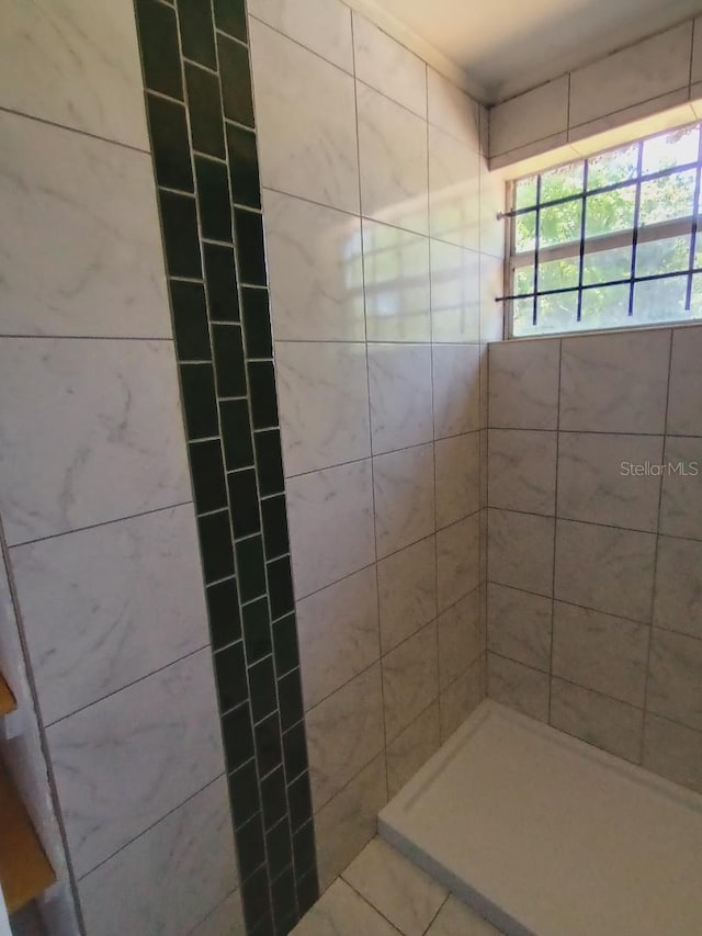 full bath with a tile shower