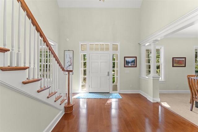 4000 Rouse Rd, Orlando, FL 32817 - foyer entrance with baseboards, stairway, wood finished floors, and a high ceiling