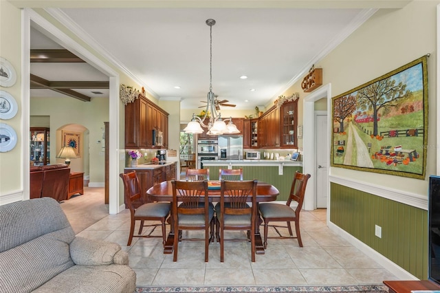 4000 Rouse Rd, Orlando, FL 32817 - dining room featuring light tile patterned floors, arched walkways, recessed lighting, ornamental molding, and wainscoting