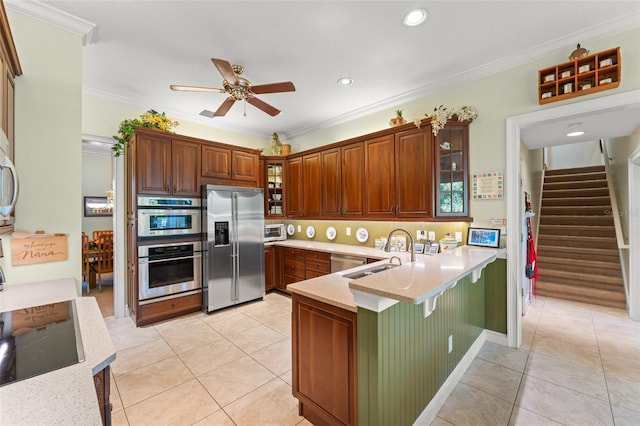 4000 Rouse Rd, Orlando, FL 32817 - kitchen featuring a peninsula, light tile patterned flooring, a sink, and appliances with stainless steel finishes