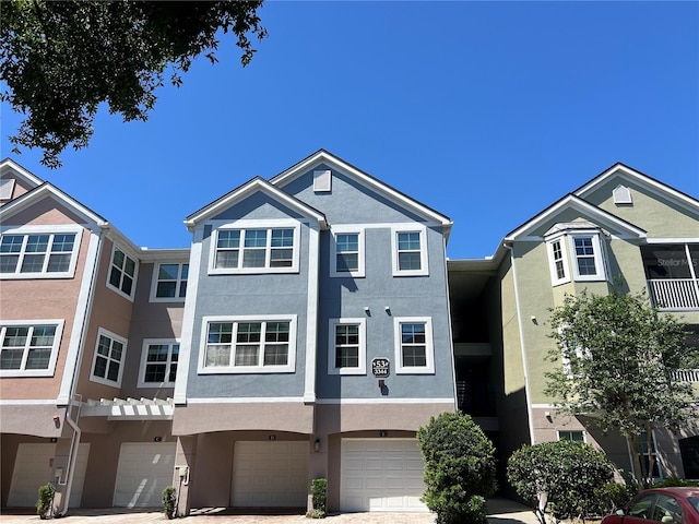 3344 Corona Village Way Unit 205, Orlando, FL 32835 - view of property featuring an attached garage and stucco siding