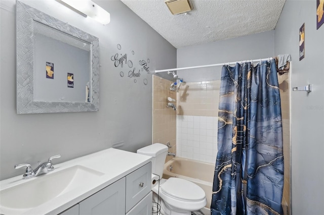 bathroom with a textured ceiling, vanity, toilet, and shower / tub combo