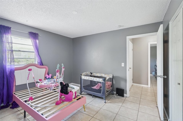 bedroom with tile patterned flooring and a textured ceiling