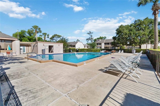 pool with fence and a patio area