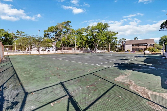 view of tennis court featuring fence