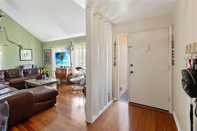 entryway featuring lofted ceiling and light wood-type flooring