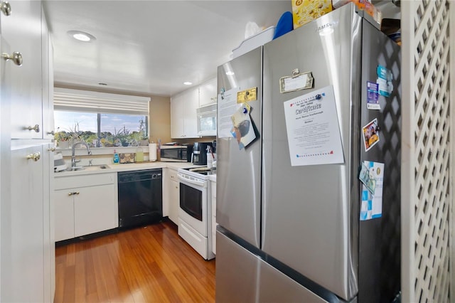 kitchen featuring dark wood-style flooring, white cabinetry, appliances with stainless steel finishes, and a sink