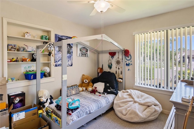 bedroom with carpet flooring, ceiling fan, and a baseboard radiator