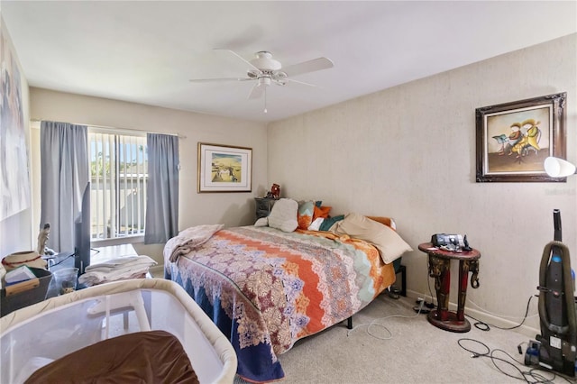 carpeted bedroom featuring baseboards, a ceiling fan, and access to exterior