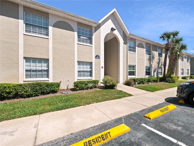 view of building exterior featuring uncovered parking