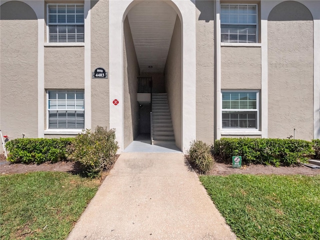 property entrance with stucco siding