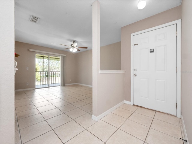 foyer entrance with light tile patterned floors, baseboards, visible vents, and ceiling fan