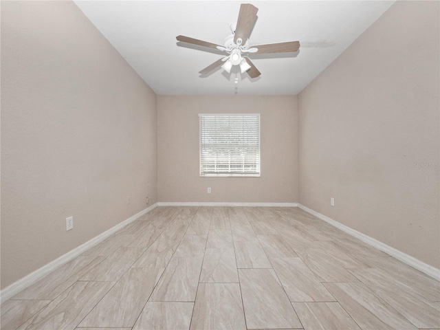 unfurnished room with baseboards and a ceiling fan