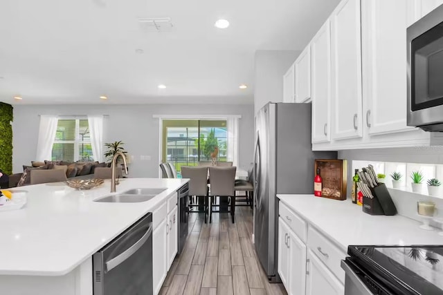 2616 Calistoga Ave, Kissimmee, FL 34741 - kitchen with white cabinets, stainless steel appliances, light countertops, and a sink