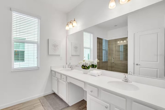 2616 Calistoga Ave, Kissimmee, FL 34741 - bathroom with wood finished floors, a sink, a shower stall, and double vanity