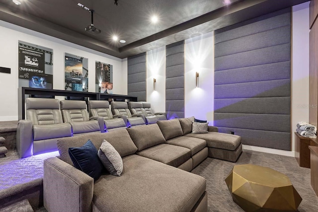carpeted cinema room featuring baseboards, recessed lighting, and a tray ceiling