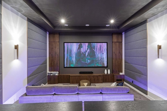 home theater room with recessed lighting, a raised ceiling, carpet floors, and baseboards