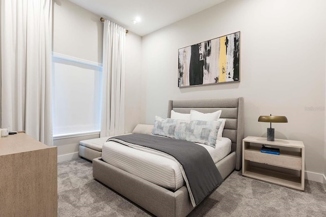 bedroom with carpet floors and baseboards