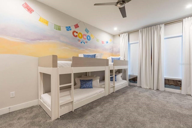 carpeted bedroom with ceiling fan and baseboards