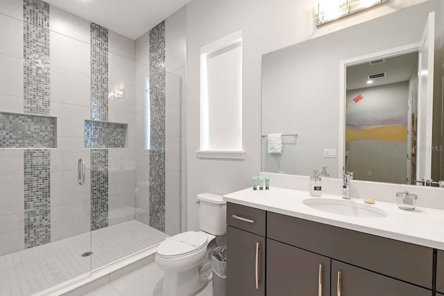 bathroom featuring visible vents, vanity, a shower stall, and toilet