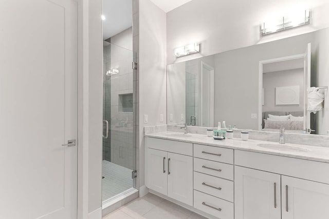 bathroom featuring connected bathroom, a shower stall, tile patterned floors, and a sink