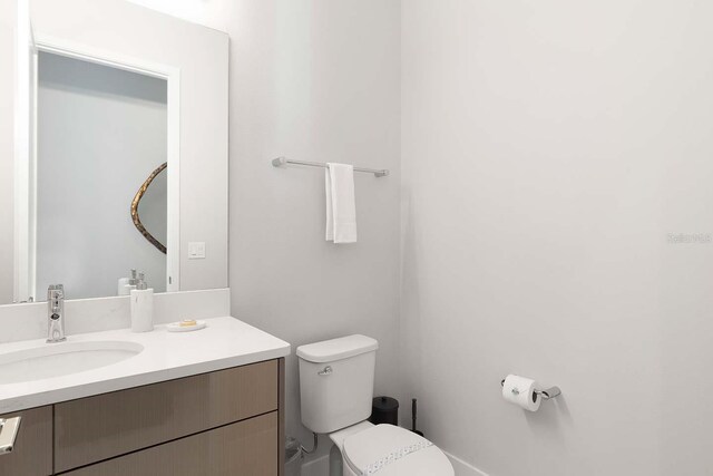 bathroom with toilet and vanity