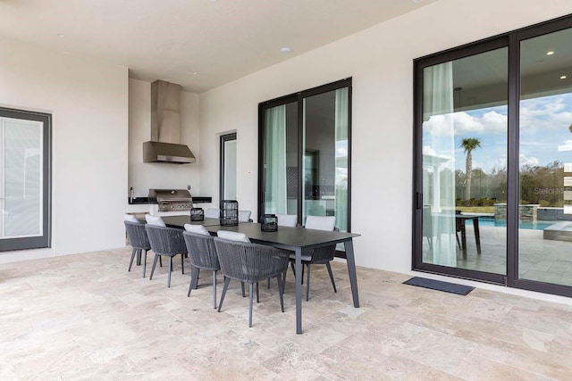 view of patio with an outdoor kitchen, outdoor dining space, and area for grilling