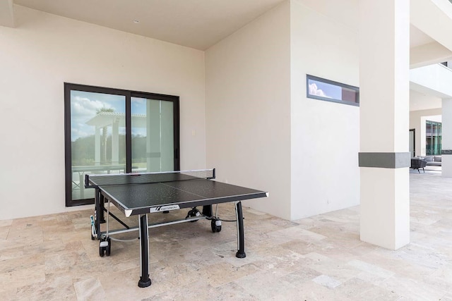 recreation room featuring stone finish flooring