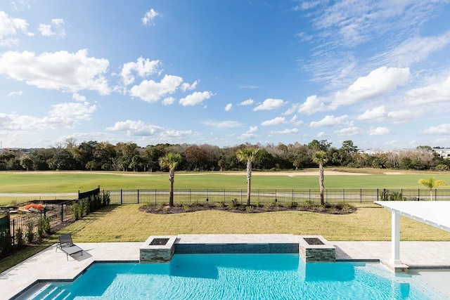 view of pool featuring a lawn, a fenced in pool, a hot tub, and view of golf course