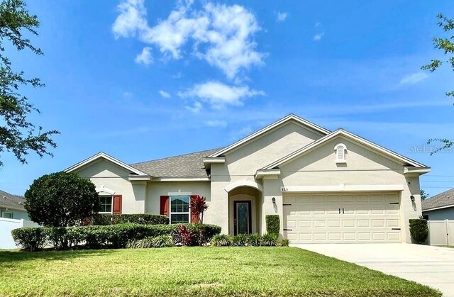 865 Bay Bridge Cir, Apopka, FL 32703 - single story home with driveway, a garage, and stucco siding