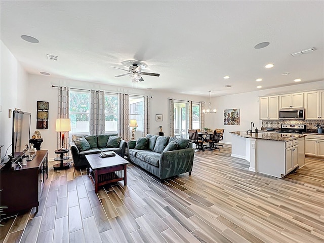 865 Bay Bridge Cir, Apopka, FL 32703 - living area featuring ceiling fan, light wood finished floors, recessed lighting, baseboards, and a chandelier
