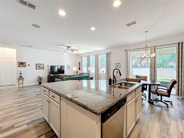 865 Bay Bridge Cir, Apopka, FL 32703 - kitchen with stainless steel dishwasher, a sink, a kitchen island with sink, light wood finished floors, and ceiling fan