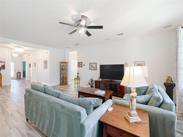 865 Bay Bridge Cir, Apopka, FL 32703 - living area featuring a ceiling fan and a textured ceiling