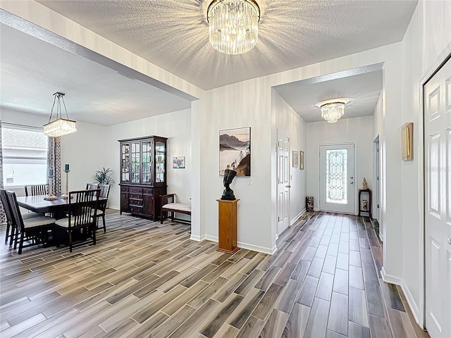 865 Bay Bridge Cir, Apopka, FL 32703 - entryway with a chandelier, wood finished floors, plenty of natural light, and a textured ceiling